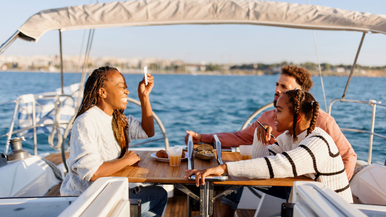 Happy family having a lunch on the yacht